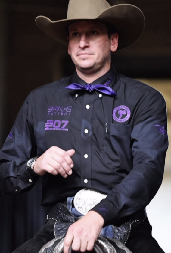 Portrait of a western rider wearing a cowboy hat and purple bow tie